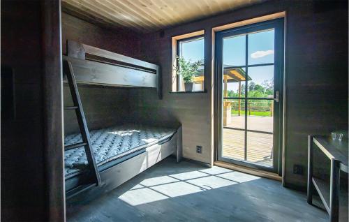 a room with a bunk bed and a window at Cozy Home In Äspered With Sauna in Dalsjöfors