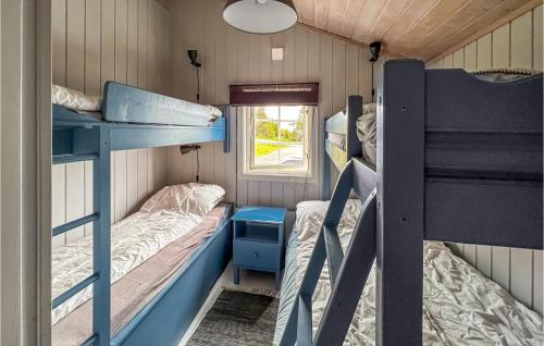 a room with two bunk beds and a window at 3 Bedroom Amazing Home In Lillehammer in Lillehammer