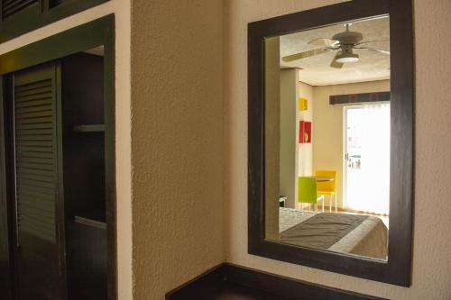 a mirror on a wall in a room at Suites Los Arcos in Isla Mujeres
