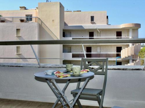 - un balcon avec une petite table et des chaises dans l'établissement Appartement 2P. avec vue mer et climatisation, Villeneuve-Loubet Plage - FR-1-252A-107, à Villeneuve-Loubet