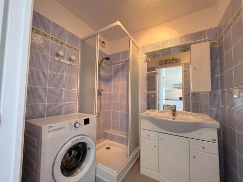 une salle de bain avec une machine à laver et un lavabo dans l'établissement Appartement moderne 2 pièces avec clim, parking à Cavalaire - FR-1-226B-164, à Cavalaire-sur-Mer