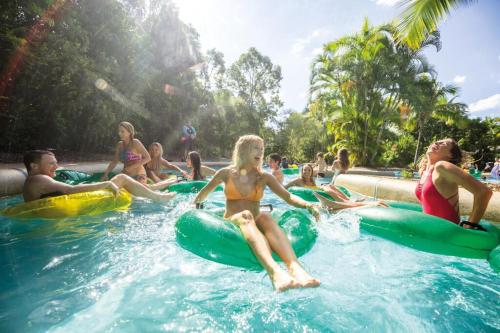 a group of people sitting on rafts in the water at Newly Furnished Spacious 3BR Townhouse at GC in Gold Coast