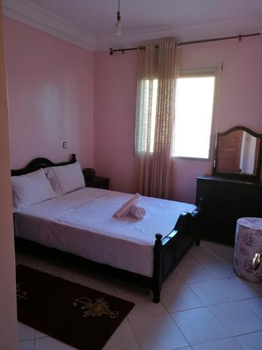 a bedroom with a large bed with a window at CasaCalma in Casablanca