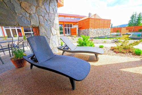 two chairs sitting on top of a patio at Klostermann Wellness&Spa in Frymburk