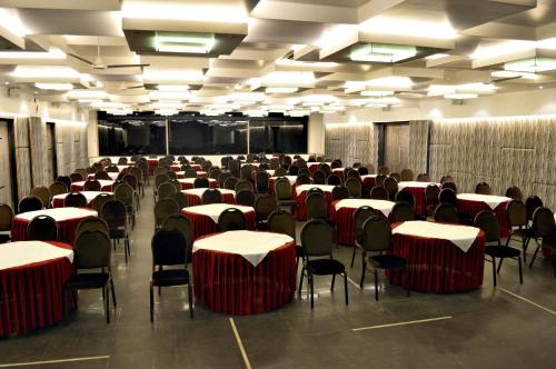 a room with tables and chairs in a room at Malligi,Hampi in Hospet