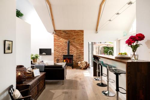 a living room with a bar and a fireplace at The Studio in Pevensey