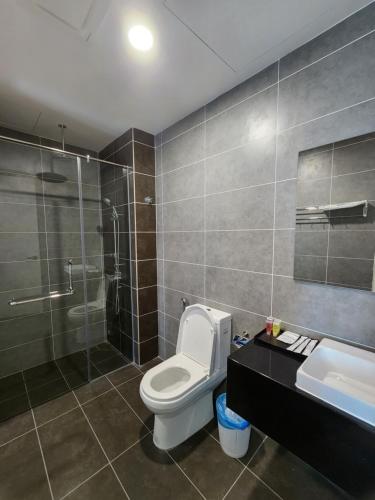 a bathroom with a toilet and a shower and a sink at Sunway onsen suite ipoh in Ipoh