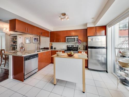 a kitchen with wooden cabinets and a white counter top at Home in Downtown in Toronto