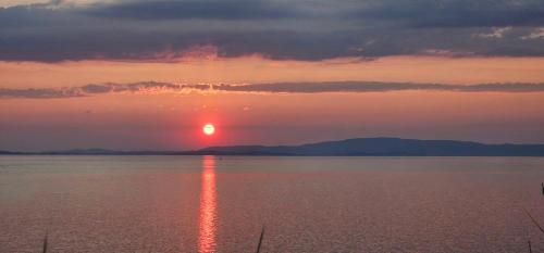 a sunset over a large body of water at Niki House in Ayios Nikolaos Sithonia
