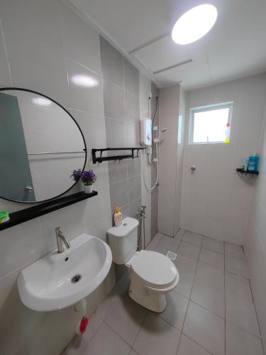 a bathroom with a sink and a toilet and a mirror at Casa Apartment @ Ipoh 【怡保民宿】 in Ipoh