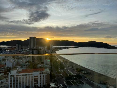 a view of the beach and the ocean at sunset at Grand Hyams Hotel - TMS Tầng 21 View Biển Quy Nhơn - 2PN in Quy Nhon