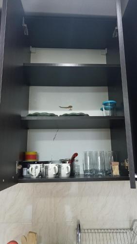 a kitchen shelf with dishes and glasses on it at Apartment Zhemchuzhina Ureki-3 СТУДИО in Ureki