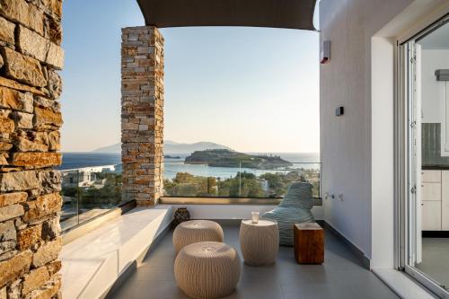 a room with a large window with a view of the ocean at Koumbara Sea View in Ios Chora