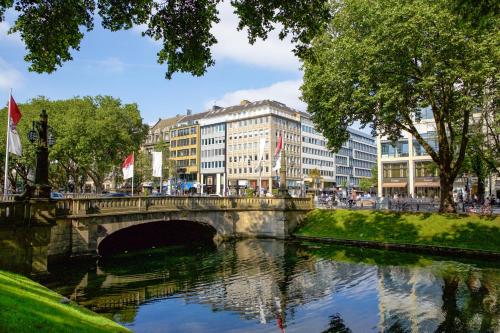 a bridge over a river in a city with buildings at Apartment Düsseldorf-Lohausen in Düsseldorf
