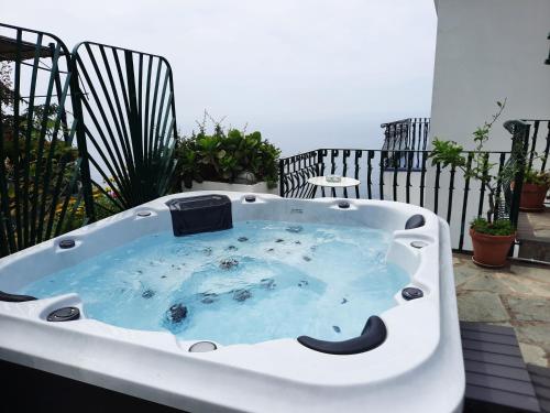 a jacuzzi tub sitting on a balcony at Le Cicale - Apartments in Conca dei Marini