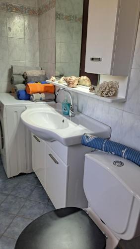 a bathroom with a sink and a toilet at Βlueview in Ermioni
