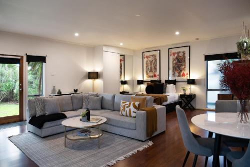 a living room with a couch and a table at Minni Gums- a perfect romantic getaway in Daylesford