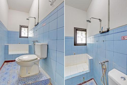a blue and white bathroom with a toilet and a tub at SPOT ON 92623 Mw 46 Guesthouse in Yogyakarta