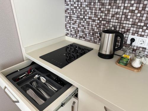 a kitchen counter with a stove top oven in a kitchen at Dream Apartments Batumi in Batumi