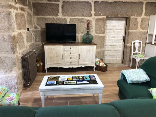 a living room with a tv and a coffee table at Casa Lisboana in Pontevedra