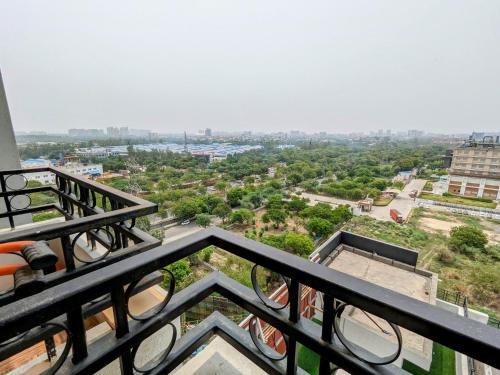 a view of a city from the balcony of a building at PLUTO HOMES in Greater Noida
