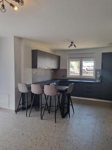 a kitchen with a table and chairs in a room at Apartments Ivanov in Zadar