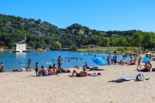 a group of people laying on a beach at Mobile-home dans camping 4 étoiles in Condrieu