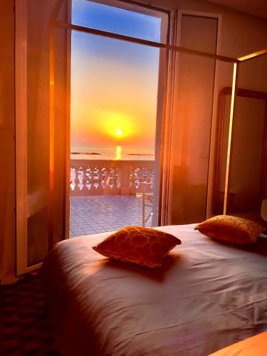 a bedroom with a bed with a view of the sunset at Villa La Torretta Luxury B&B - Adults Only - in Rimini