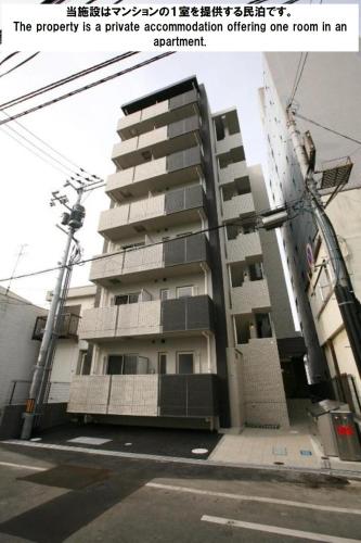 a apartment building with the words the property is a private accommodation offering room at COCOSTAY月光千日前3F - Cocostay Gekkou Sennichimae3F in Okayama