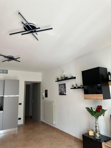 a living room with white walls and a flat screen tv at La balena bianca house in Bagni San Filippo