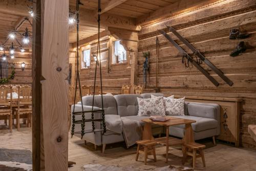 a living room with a couch and a table at Willa Bór in Zakopane