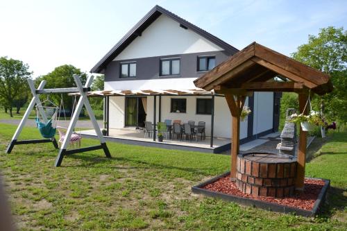 a house with a playground and a swing at Villa River and Sky in Bihać