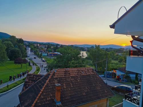 a sunset over a city with a roof at Vila Sunset in Soko Banja