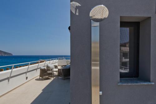 a view of the ocean from the balcony of a building at Arcus Luxury Suites Karpathos in Karpathos Town
