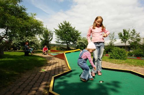 two little girls playing on a trampoline at Panorama Hotel Oberwiesenthal in Kurort Oberwiesenthal