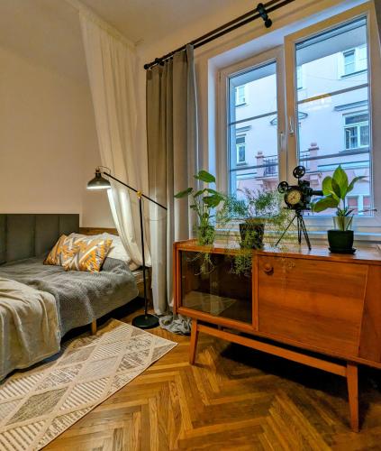 a living room with a couch and a table and a window at APARTAMENT VINTAGE parter in Płock
