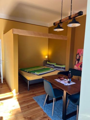 a living room with a bed and a table and chairs at Forsthaus Neudorf - Gartenblick in Harzgerode
