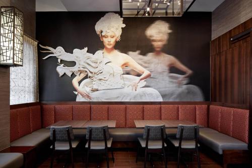 a large painting of a woman on a wall in a restaurant at Fairfield Inn & Suites by Marriott Washington Downtown in Washington