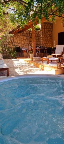 a large pool of blue water next to a patio at Salt & Stone Villa in Pag