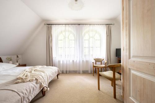 a bedroom with a bed and a desk and a window at Willa Bór in Zakopane