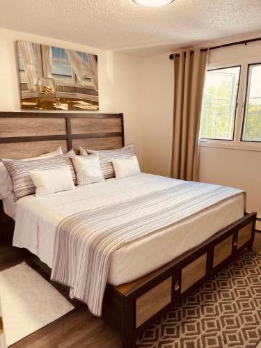 a large bed in a room with a window at North Star Place 11 in Fairbanks