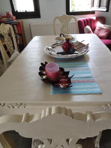 a white table with a plate of food on it at Dimosthenis Karastamatis Rooms in Xorychti