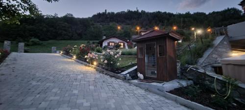 a garden with a small building with lights on it at Lo Noyer et les Roses in Saint Nicolas
