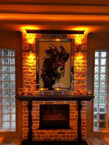 a brick fireplace with a portrait of a woman on it at Pearl of Black Sea in Rize