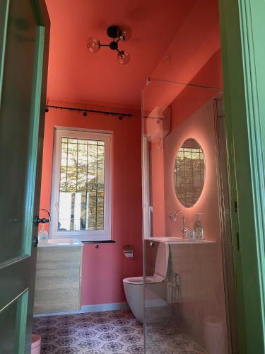 a bathroom with a toilet and a sink and a window at Villa Monte Rosa al Golfo by PortofinoVacanze in Rapallo