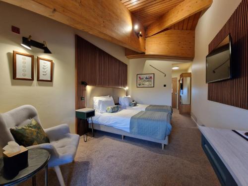 a hotel room with a bed and a tv at Dorset Resort Hotel in East Stoke