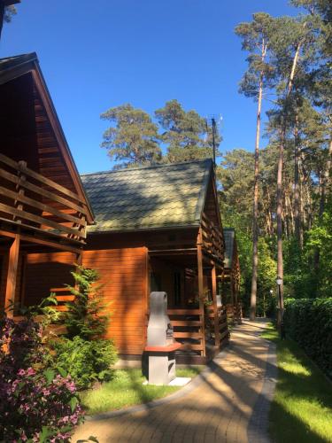 a house with a pathway next to a building at Pinia in Pobierowo