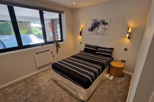 a bedroom with a bed and a large window at Dream apartment Finchley 4 min walk to the train in Hendon