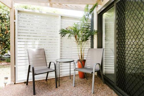 two chairs and a table on a porch at Wanda House - Close to beach Linen Pets in Salamander Bay