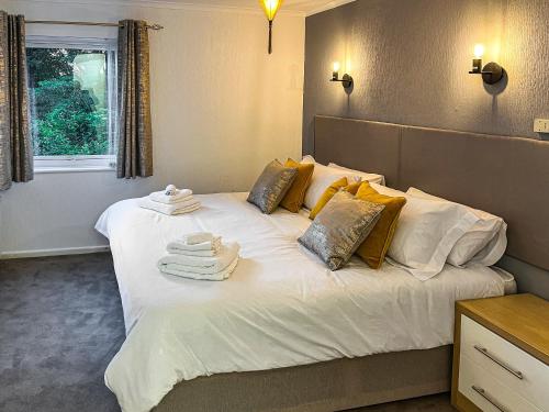 a bedroom with a large bed with towels on it at Burn View in Ryton